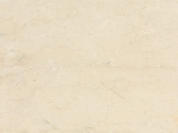 Detalhe do Mármore Crema Marfil: superfície lisa onde as linhas quase não aparecem