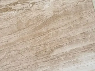 Close-up of beige Daino Reale marble: fine parallel brown and cream lines over the beige