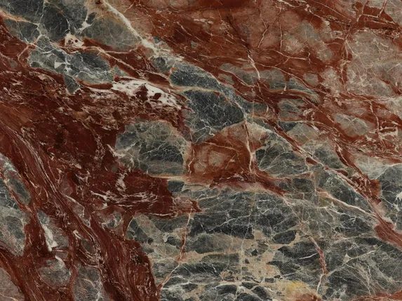Close-up of red Domus Red marble: a brecciated pattern with wine-red patches and gray fragments, brilliant polish