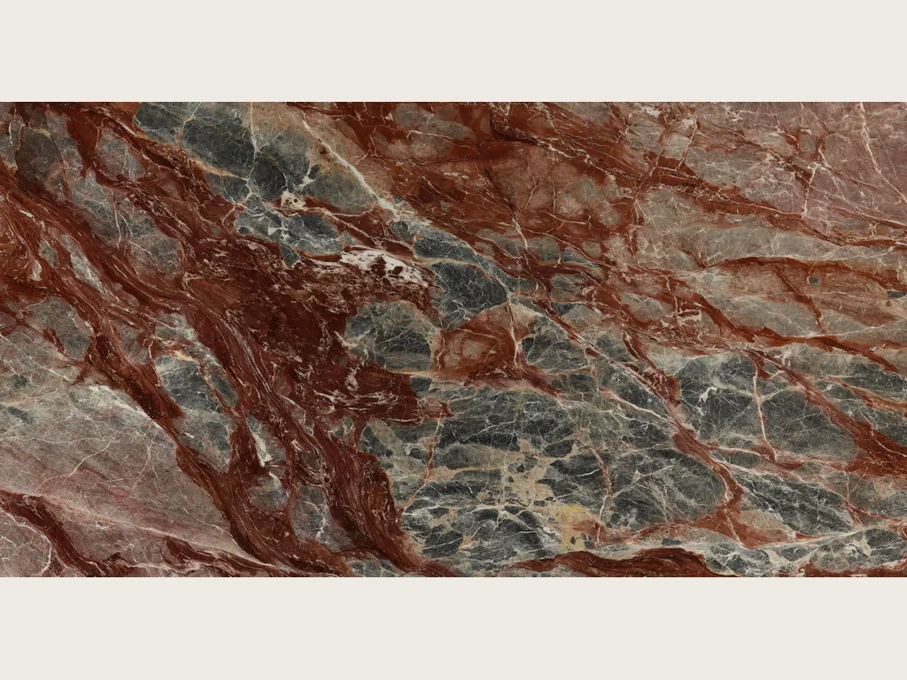 Slab of red Domus Red marble: bluish gray fragments joined by thick diagonal wine-red veins