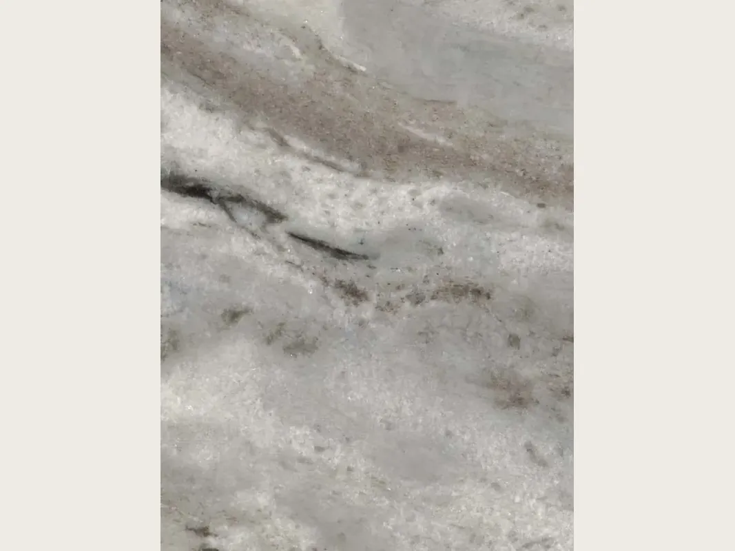 Slab of gray Fantasy Brown marble: light gray background, white clouds, diffuse bands in a soft diagonal and gray-brown streaks