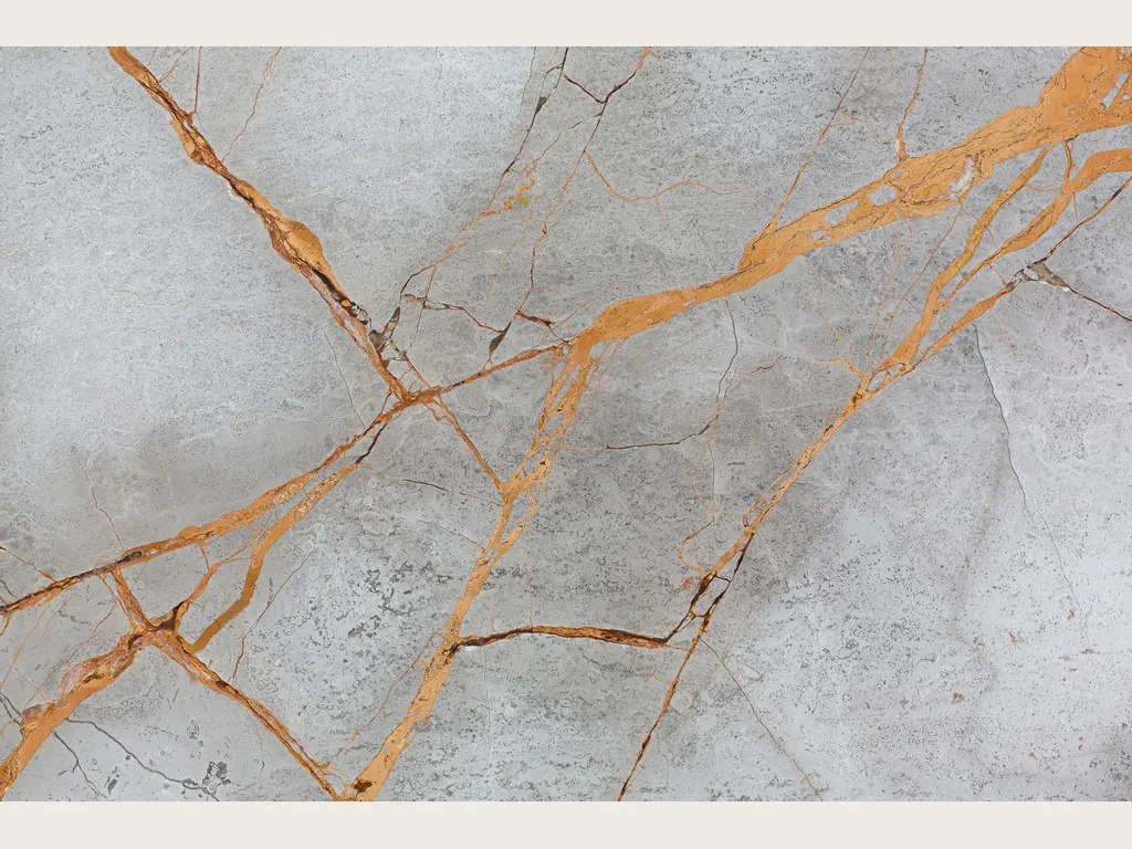 Gray Golden Sky marble slab: golden orange veins in a diagonal over a cloudy light gray background