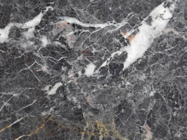 Detail of Grey Saint Laurent gray marble: fine gray veins and ochre streaks on the polished dark background