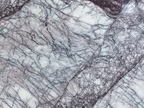 Close-up of white Lilac marble: fine violet veins over the white with the gloss of the polish