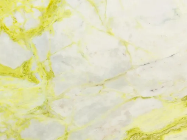 Close-up of white Luminous marble: an intense lemon yellow vein over the bluish white background