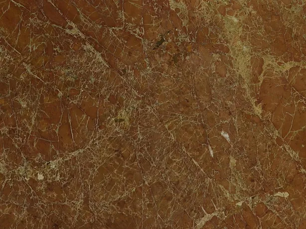 Close-up of red Melograno marble: the network of cream veins over the red with the shine of the polish