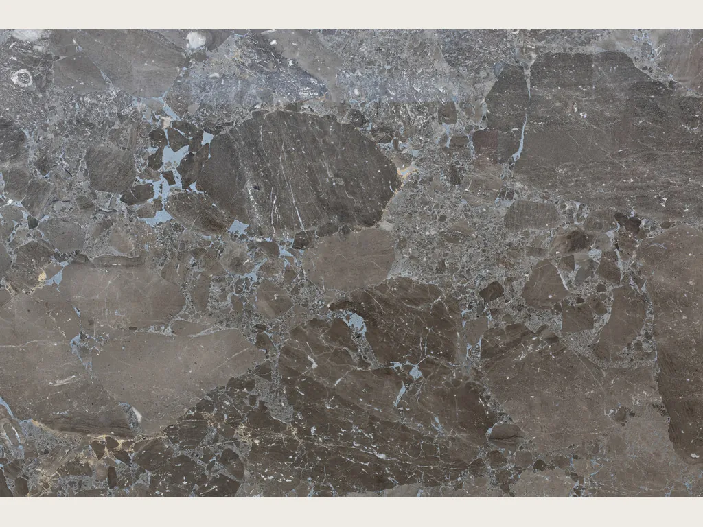 Slab of gray Moon Grey marble: angular grayish brown fragments taken up by a blue-gray matrix, polished finish