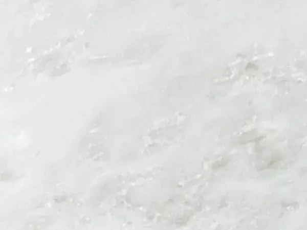 Namibia Cream Marble slab: an almost plain grayish white background with faint gray clouds on the diagonal