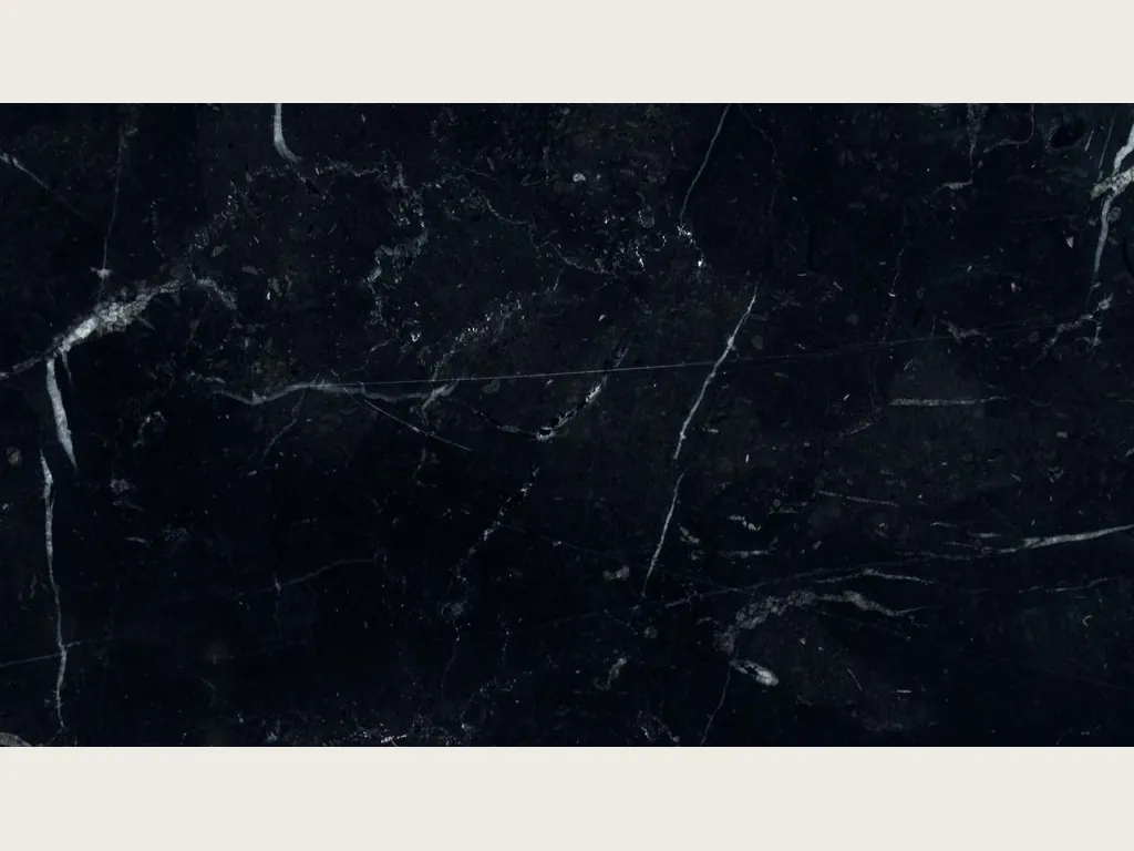 Slab of black Nero Marquina marble: deep black background with a few fine straight white veins on the diagonal (another slab)