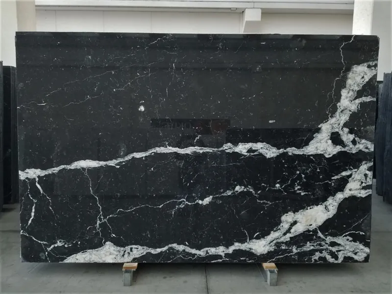 Slab of black Nero Marquina marble: deep black background with a few fine straight white veins on the diagonal (another slab)