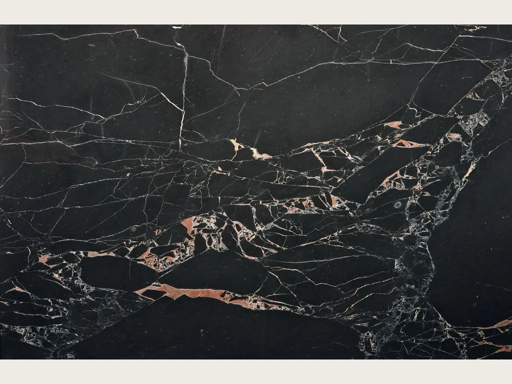 Orange Black marble slab: black background with a network of fine white veins and salmon-orange spots in a central band