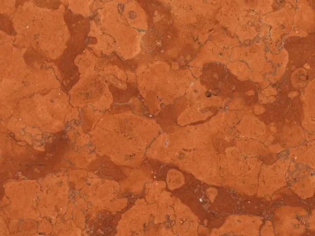 Close-up of Rosso Asiago marble: light patches over the rust-red matrix in a matte finish