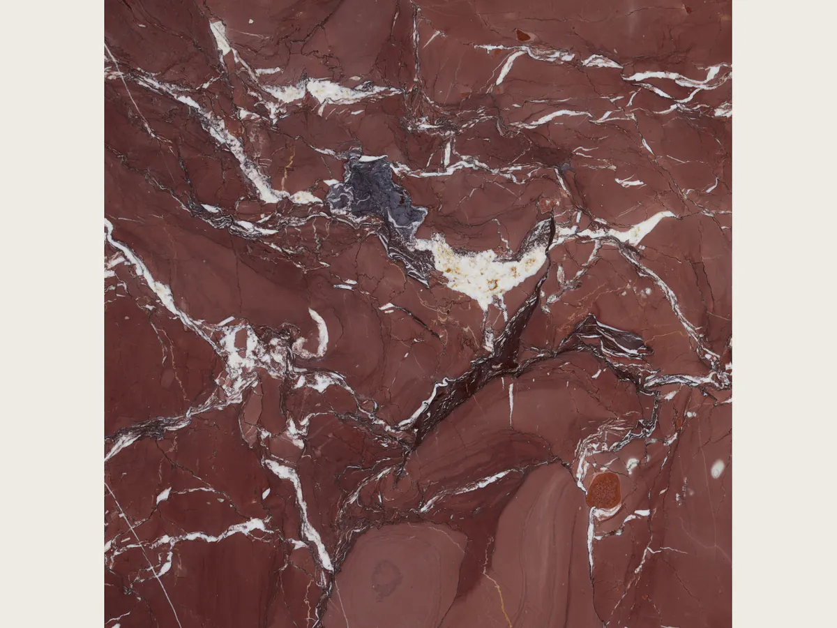 Rosso Cardinale marble slab: a burgundy background with irregular white veins and gray-violet stains