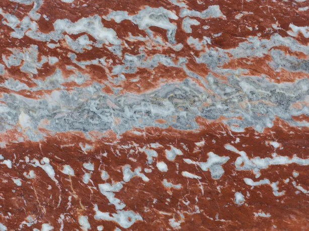 Detail of Rosso Francia marble: tight banding of red, blue-gray and white with a polished sheen