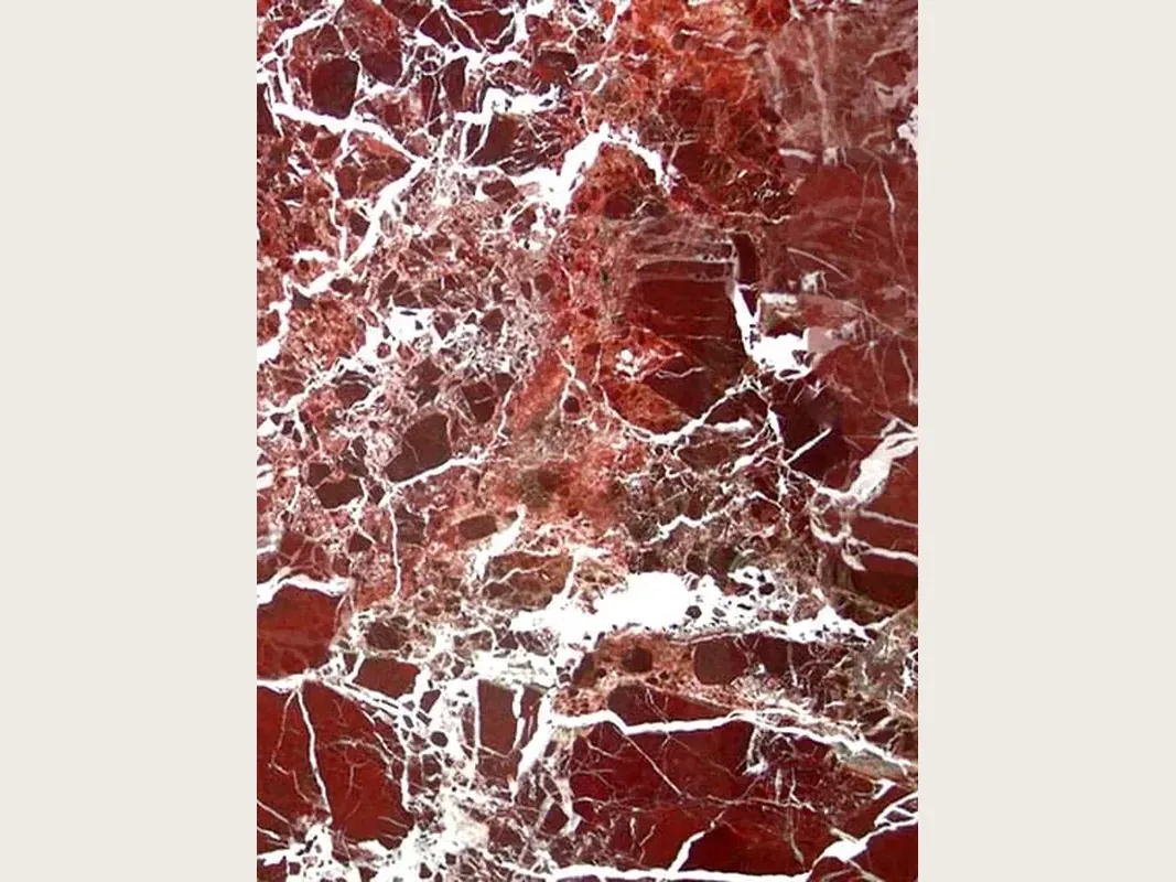 Slab of red Rosso Lepanto marble: intense red fragments separated by a dense network of white veins