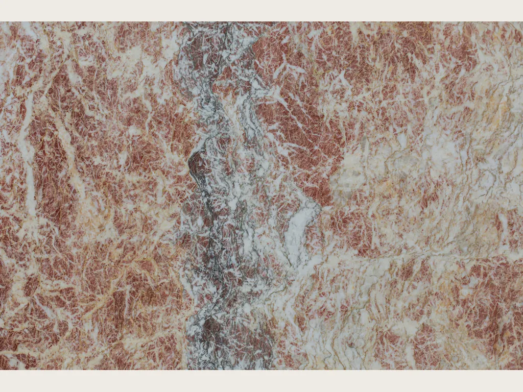 Slab of Rosa Peralba marble: reddish pink background with a net of fine white veins and a grayish-purple band