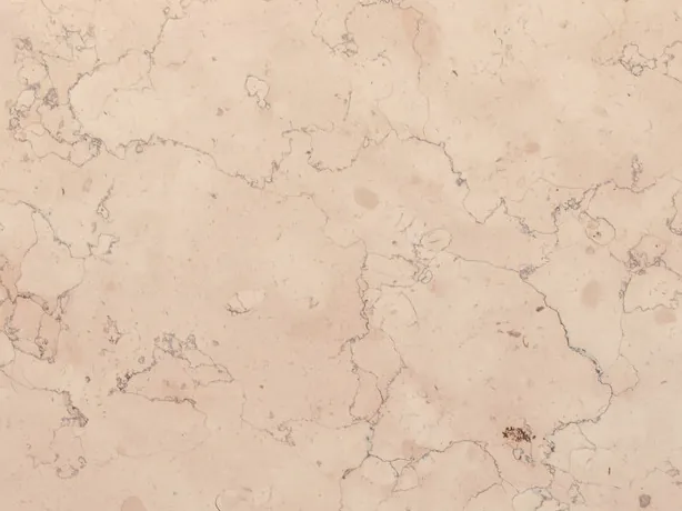 Detail of Rosa Perlino marble: light brown wavy lines on the matte pinkish beige