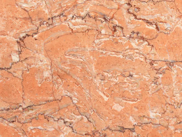 Detail of Rosa Sabrina Marble: fine white and reddish veins over the polished salmon orange