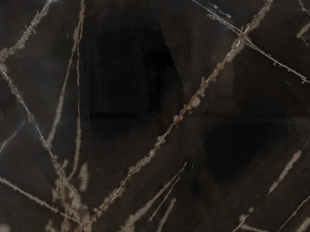 Detail of black Sahara Bronze marble: bronze strokes and beige touches on the polished dark background