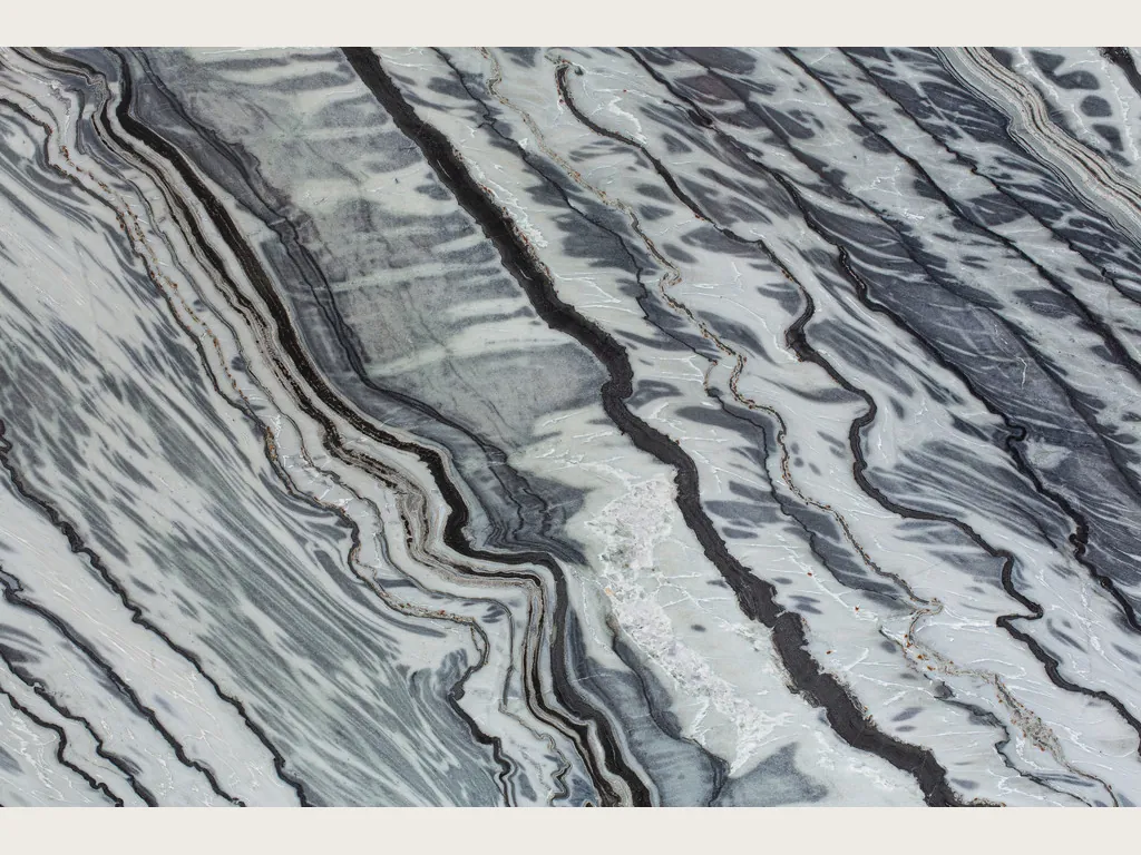 Slab of Silver Stream gray marble: black and bluish gray wavy bands in diagonal over a light background