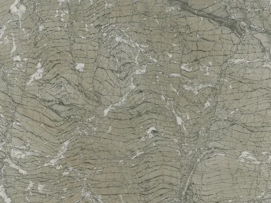 Close-up of Verde Antigua marble: fine wavy lines and white fragments over the polished grayish green