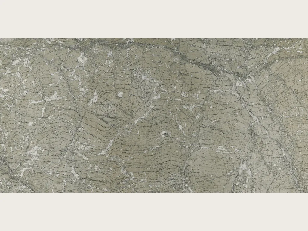 Slab of Verde Antigua marble: a grayish green background with dark gray wavy lines and scattered white fragments