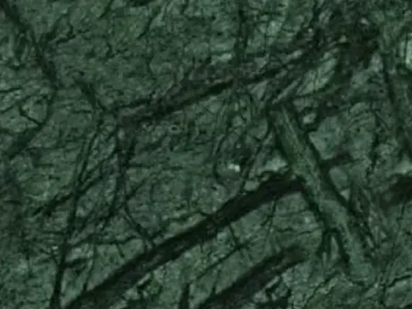 Verde Guatemala marble slab: dark green background with a diagonal network of light green veins