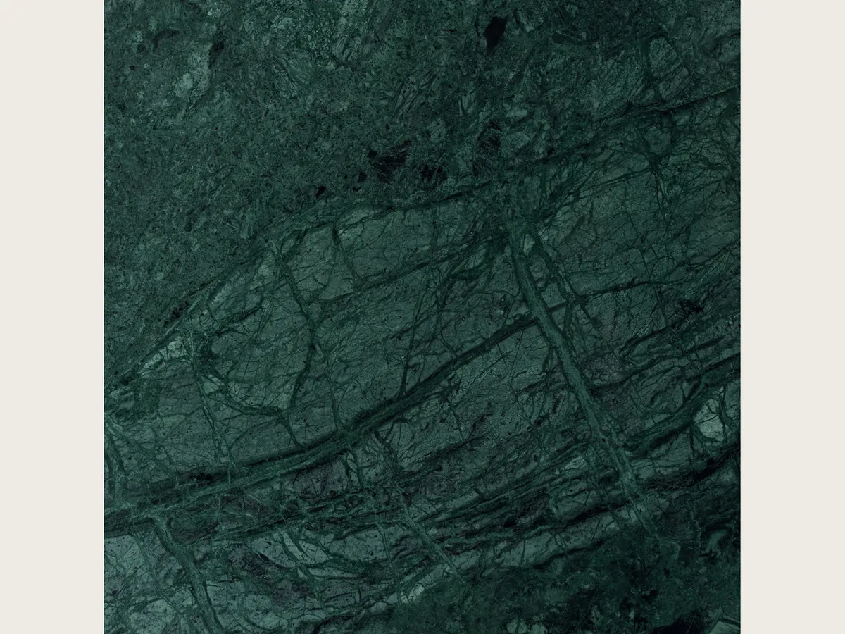 Verde Imperiale marble slab: petrol green background with a fine diagonal network of light green veins