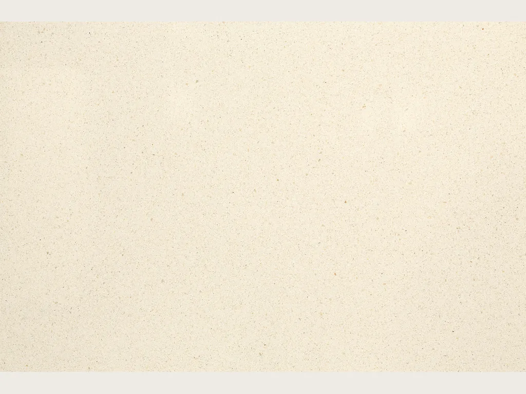 Beige Veselje marble slab: smooth light cream background, no veins, with tiny dark specks and a matte surface