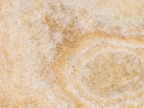 Yellow onyx detail: diffuse clouds and the oval ring over the light honey background