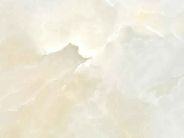 White onyx detail: soft clouds and very fine gold lines over the cream