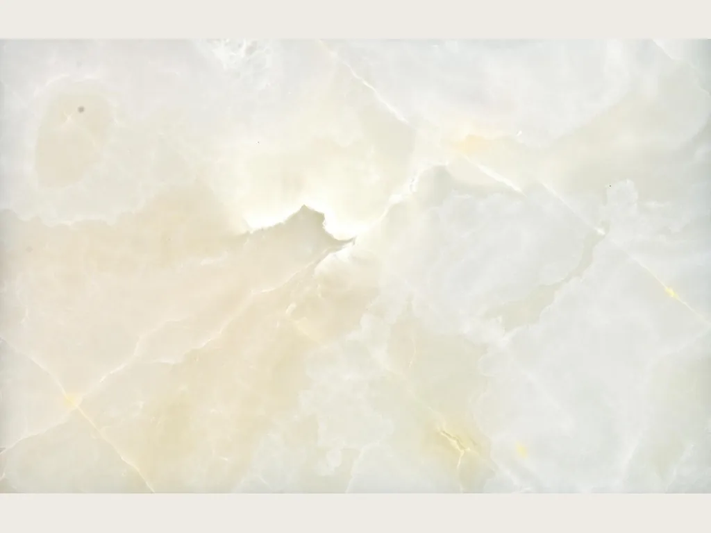 White onyx slab: creamy white background with soft clouds and fine gold lines