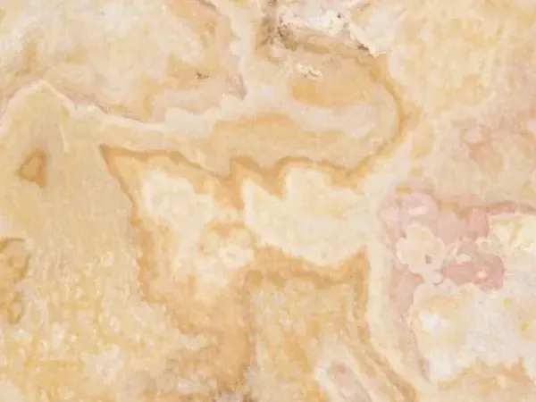 Slab of Cappuccino Onyx: cream background with winding honey-colored clouds and pink touches