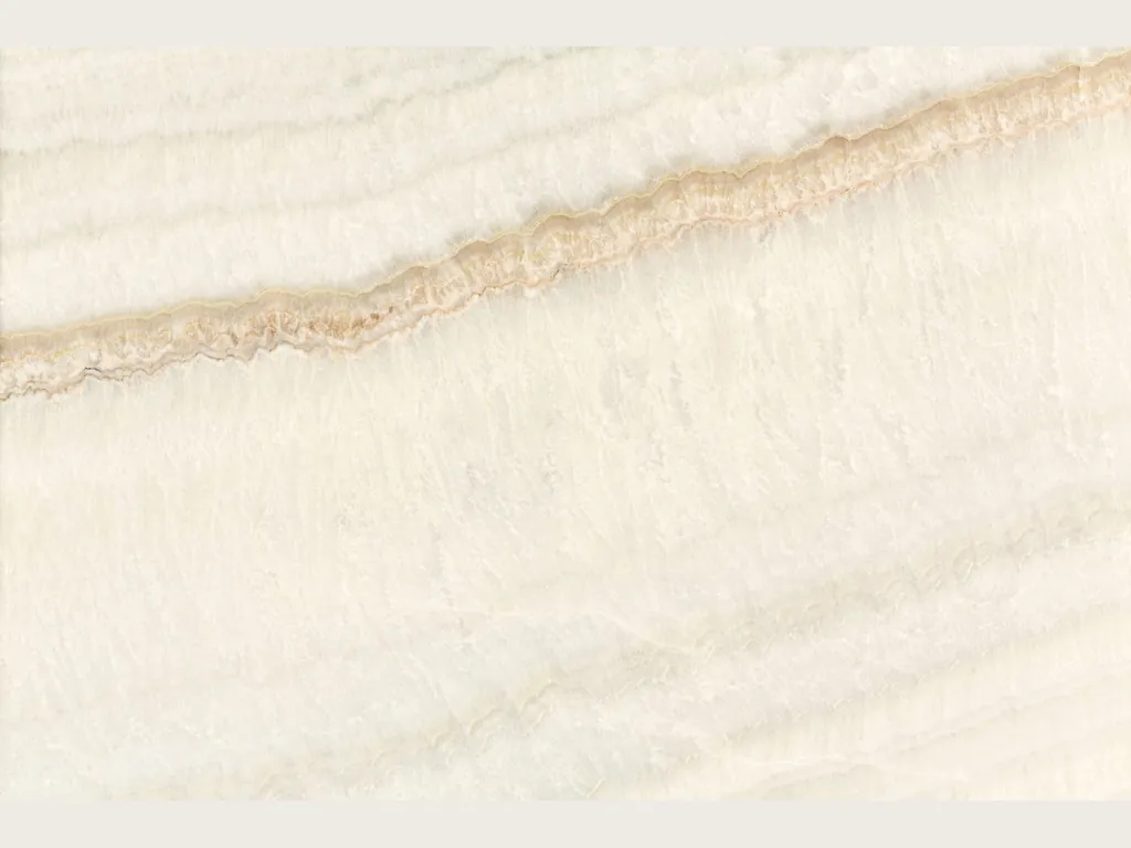 Slab of beige Ivory onyx: ivory background with soft wavy bands and a diagonal honey line