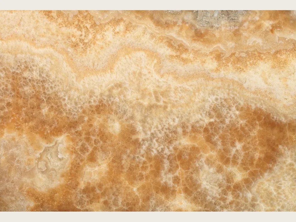 Slab of honey yellow onyx: soft horizontal bands in cream and light honey, with a vertical fibrous texture (another slab)