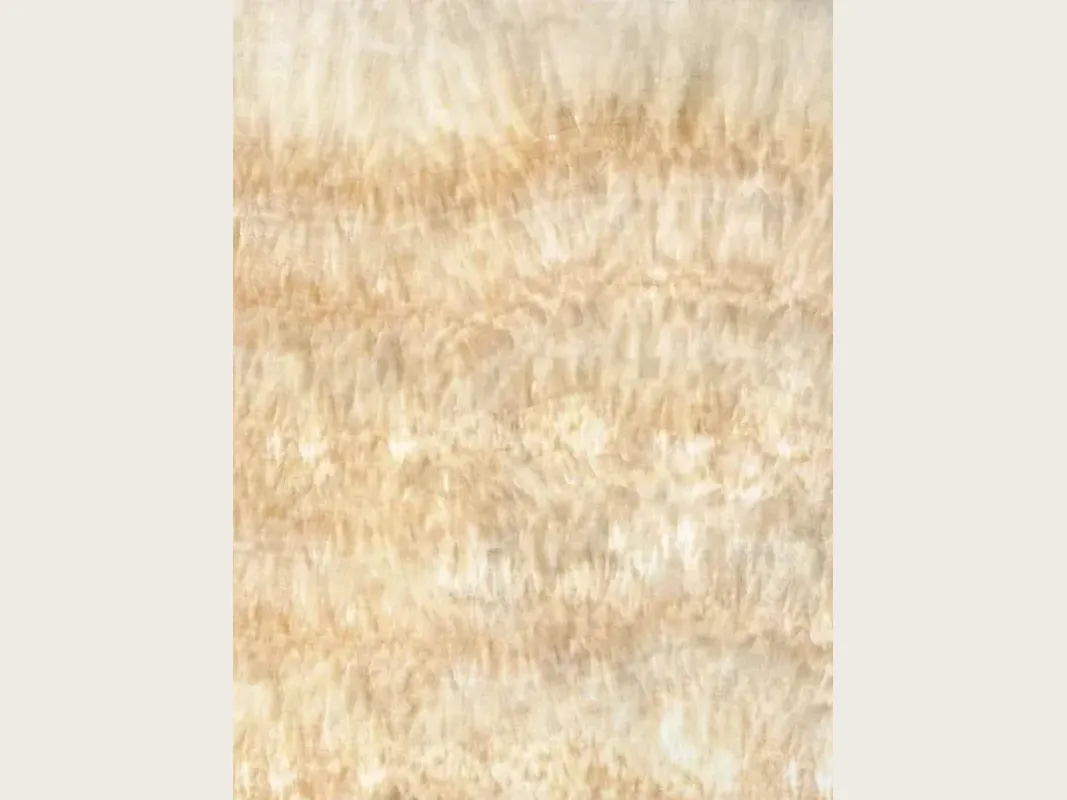 Slab of honey yellow onyx: soft horizontal bands in cream and light honey, with a vertical fibrous texture