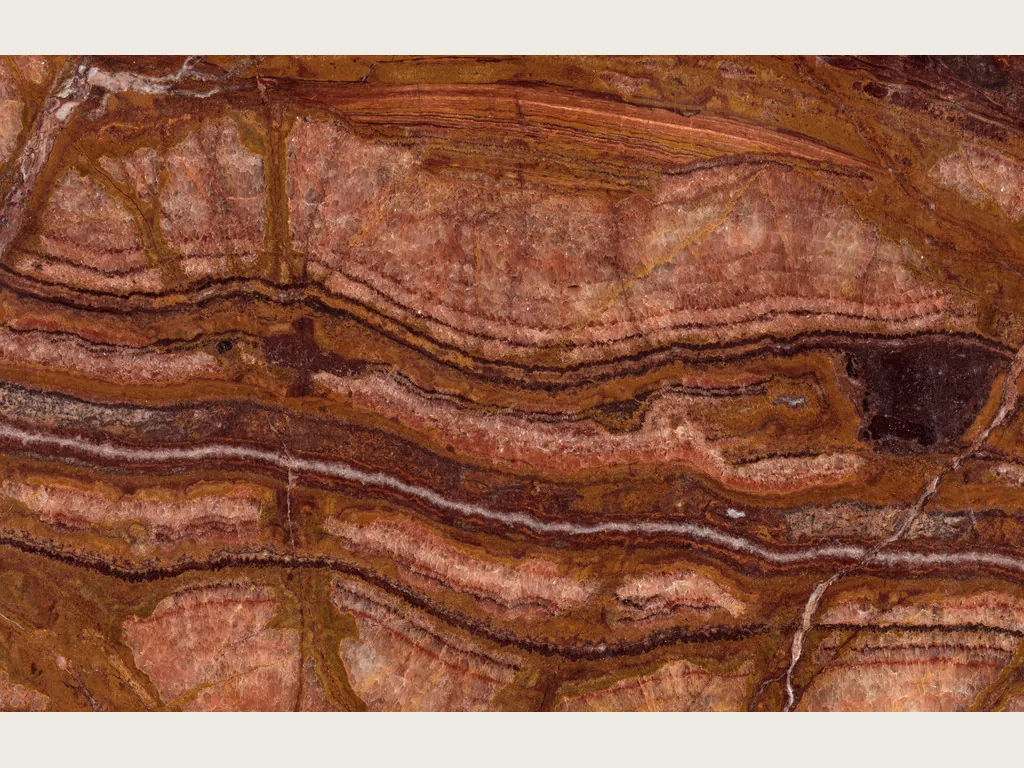 Red Onyx slab: rust-red background with irregular dark red and orange spots and a greenish ochre zone (another slab)