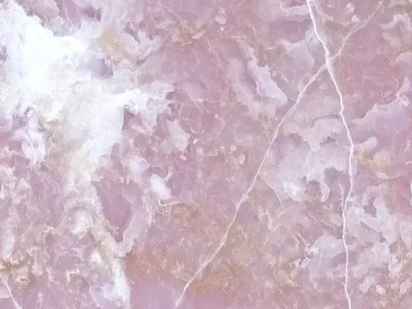 Pink Onyx slab: lilac pink background with white clouds and fine diagonal veins