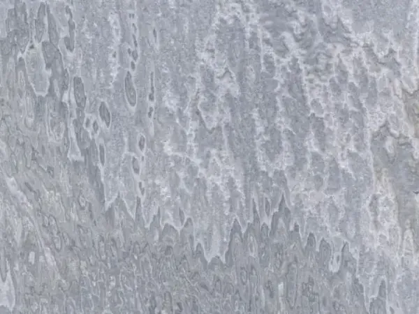 Vulcano onyx slab: wavy light patches that fall in vertical lines over bluish gray