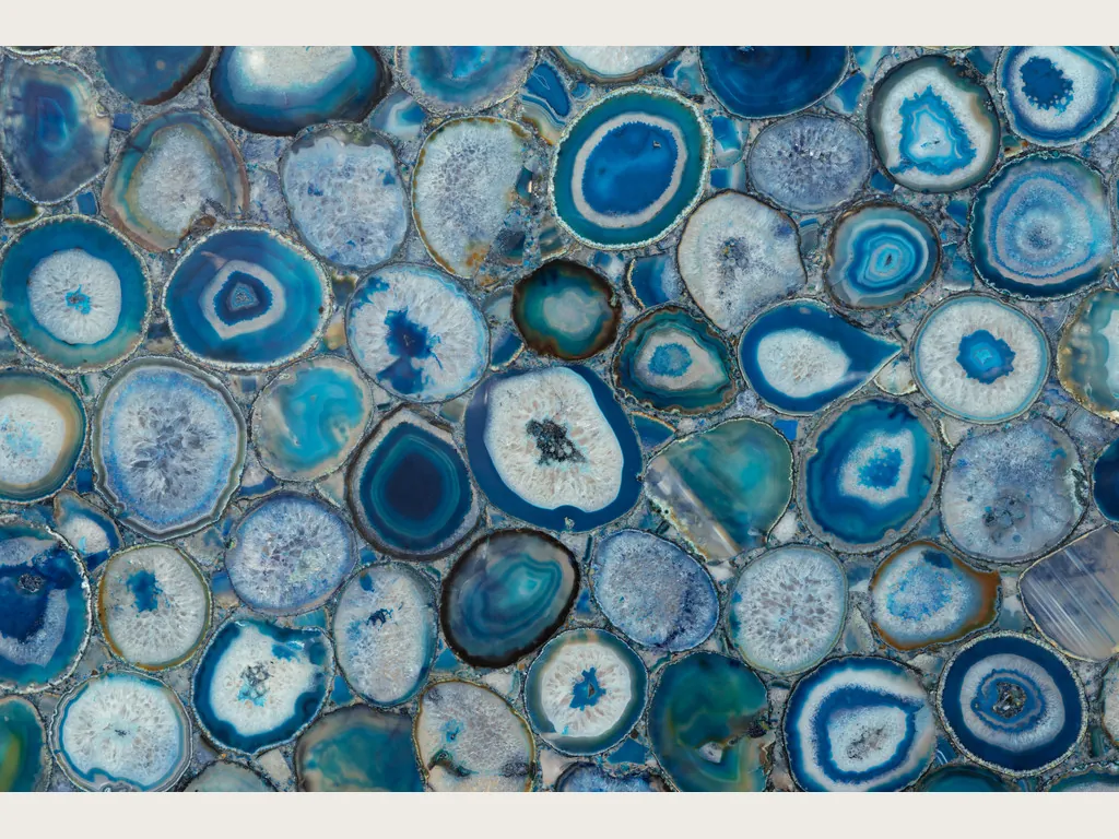 Blue agate slab: a mosaic of slices with blue rings and white centers