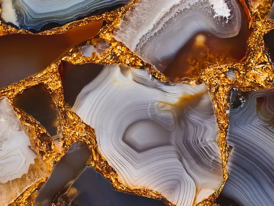 Detail of Gray Agate with Gold Leaf: gray and brown bands of the pieces and gold joints