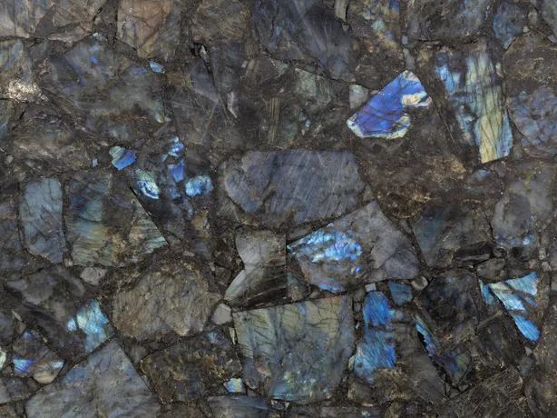 Labradorite detail: iridescent blue flashes over gray pieces