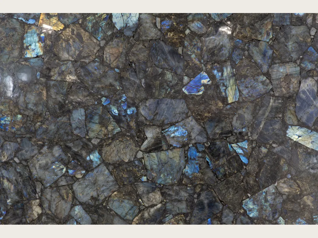 Labradorite slab: mosaic of gray pieces with iridescent blue flashes
