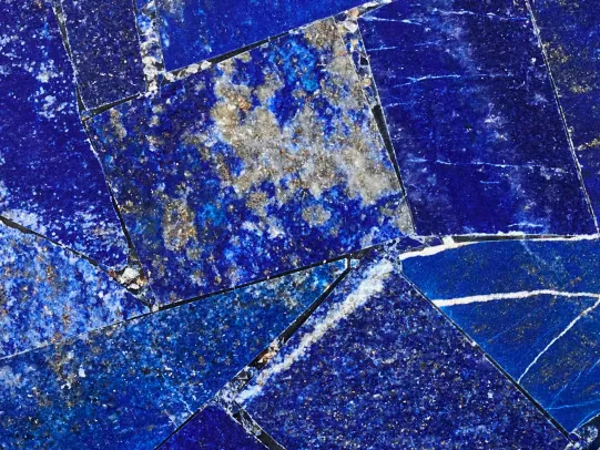 Lapis lazuli detail: intense blue pieces with white flecks and veins and gold dots