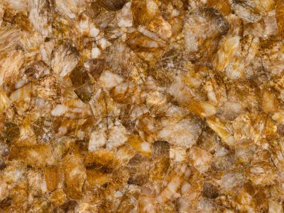 Detail of lemon quartz: elongated crystals in honey and cream on a honey ochre background
