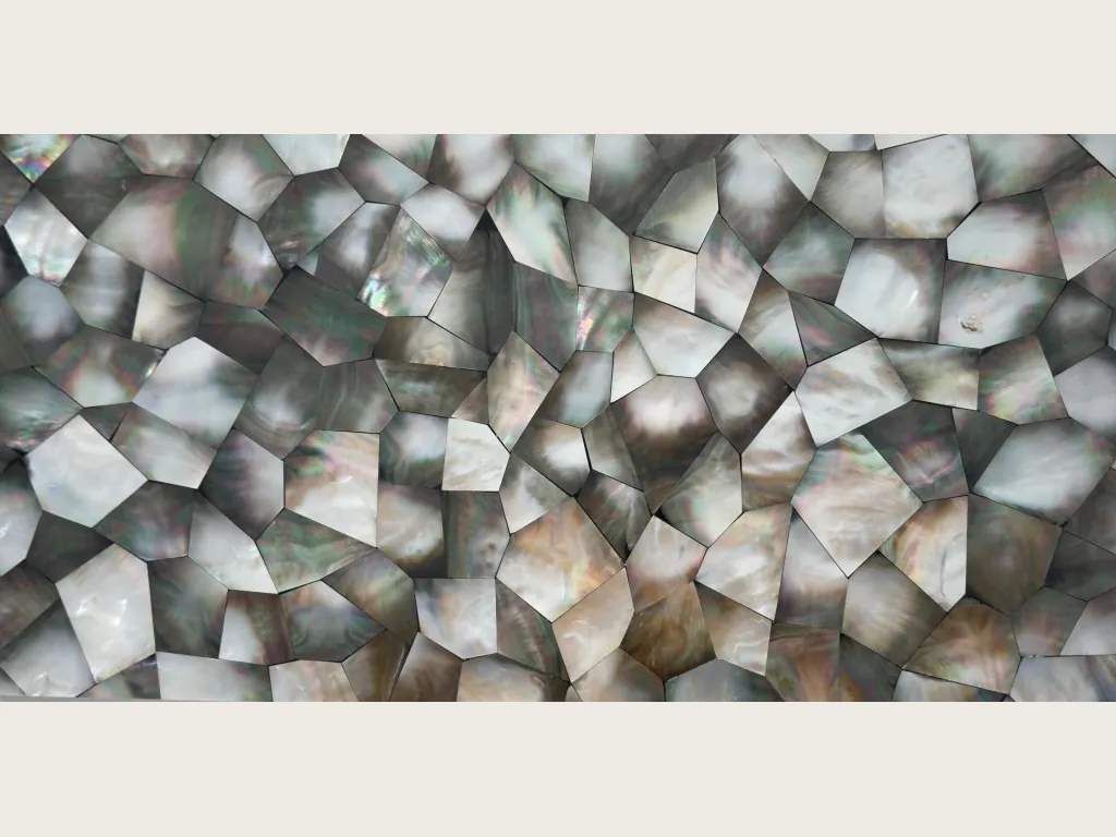 Gray Shell Mother of Pearl slab: a mosaic of polygons with an iridescent sheen and fine joints on a dark background