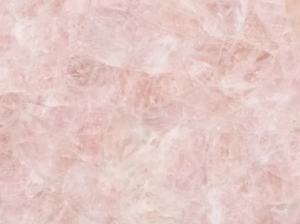 Detail of rose quartz: soft-edged fragments with a bright polish