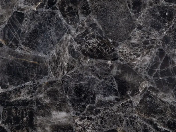 Detail of smoky quartz: light edges and white lines between crystalline fragments