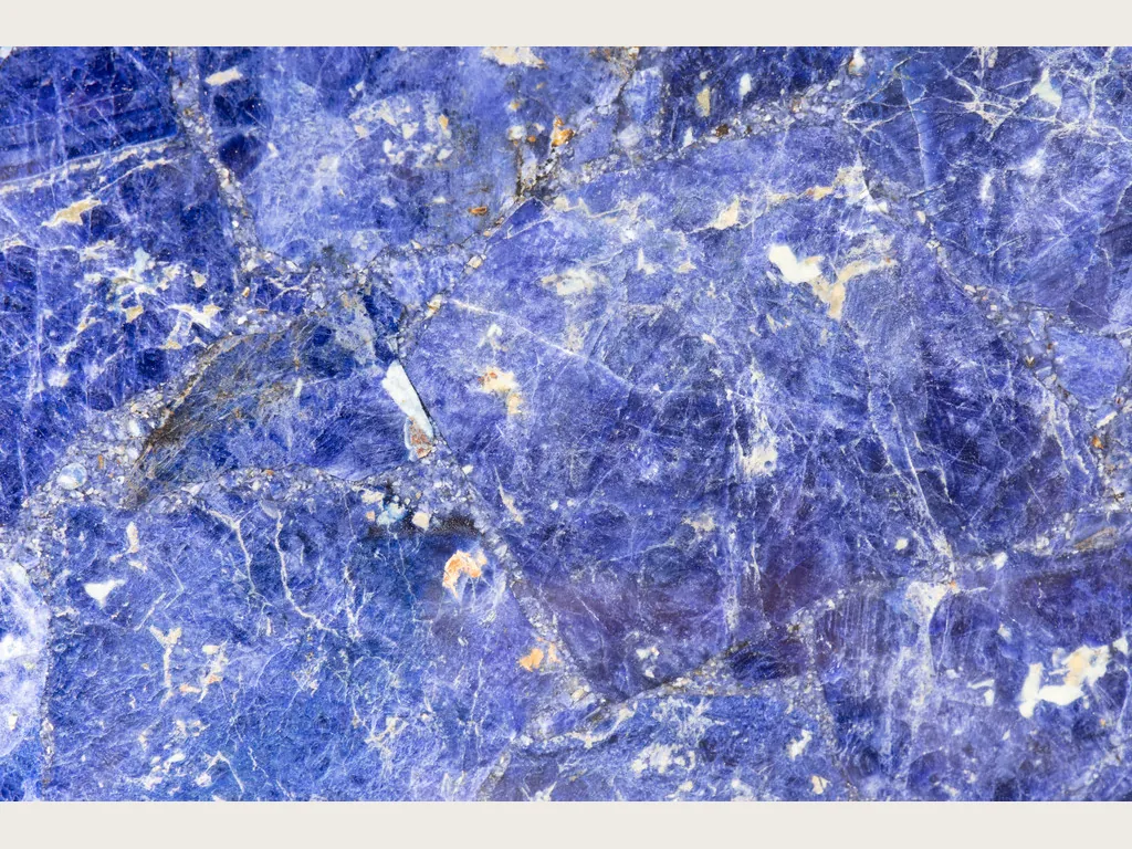 Sodalite slab: violet blue with irregular white veins and orange flecks