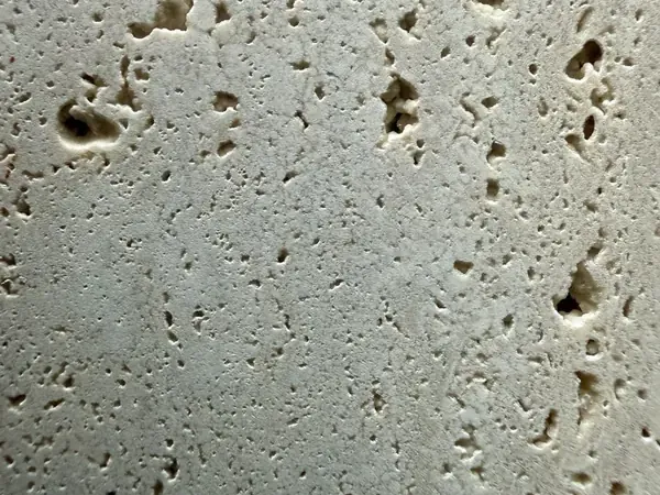 Roman travertine slab: light grayish beige background with open holes in vertical rows